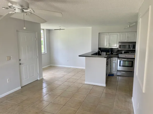 a kitchen with a refrigerator sink and stove
