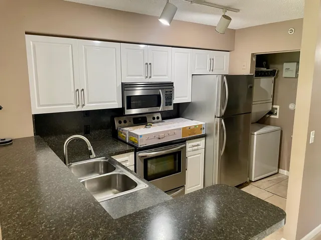 a kitchen with a sink cabinets and window