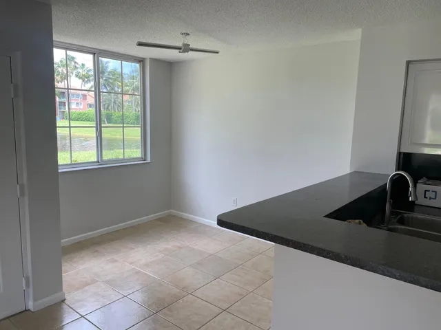 a bathroom with a granite countertop bathtub shower and toilet
