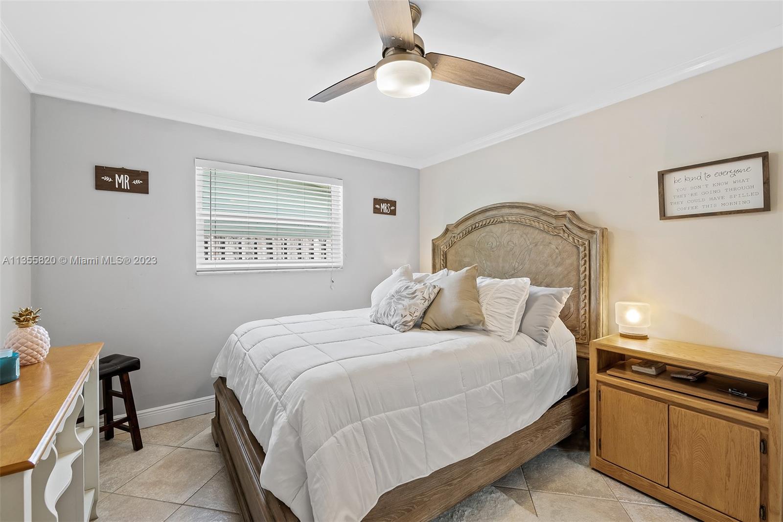 3731 Thomas Street Hollywood, FL 33021 - Photo 15 of 21 a bedroom with a bed and a chandelier
