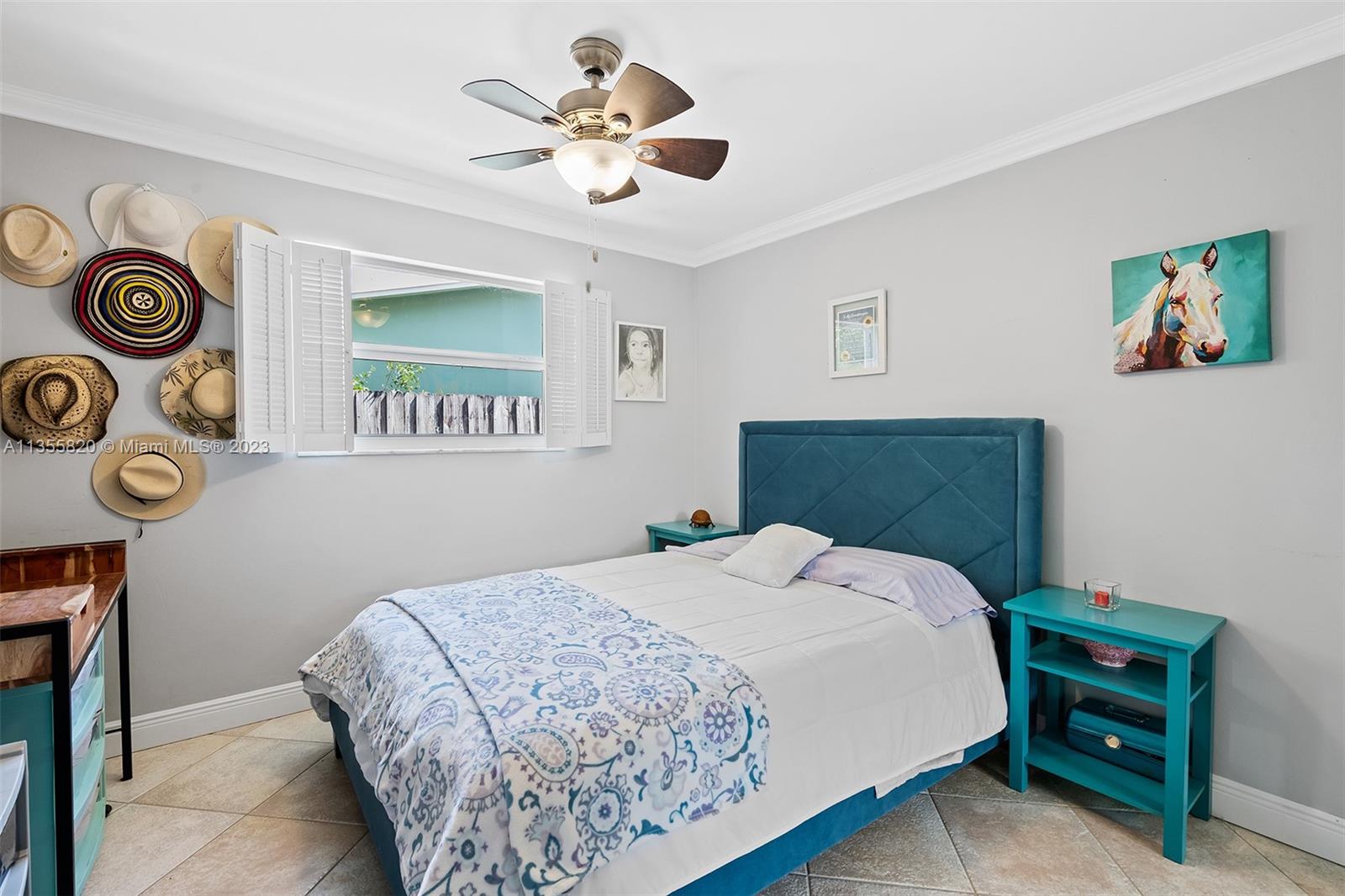 3731 Thomas Street Hollywood, FL 33021 - Photo 16 of 21 a bedroom with a bed and a chandelier