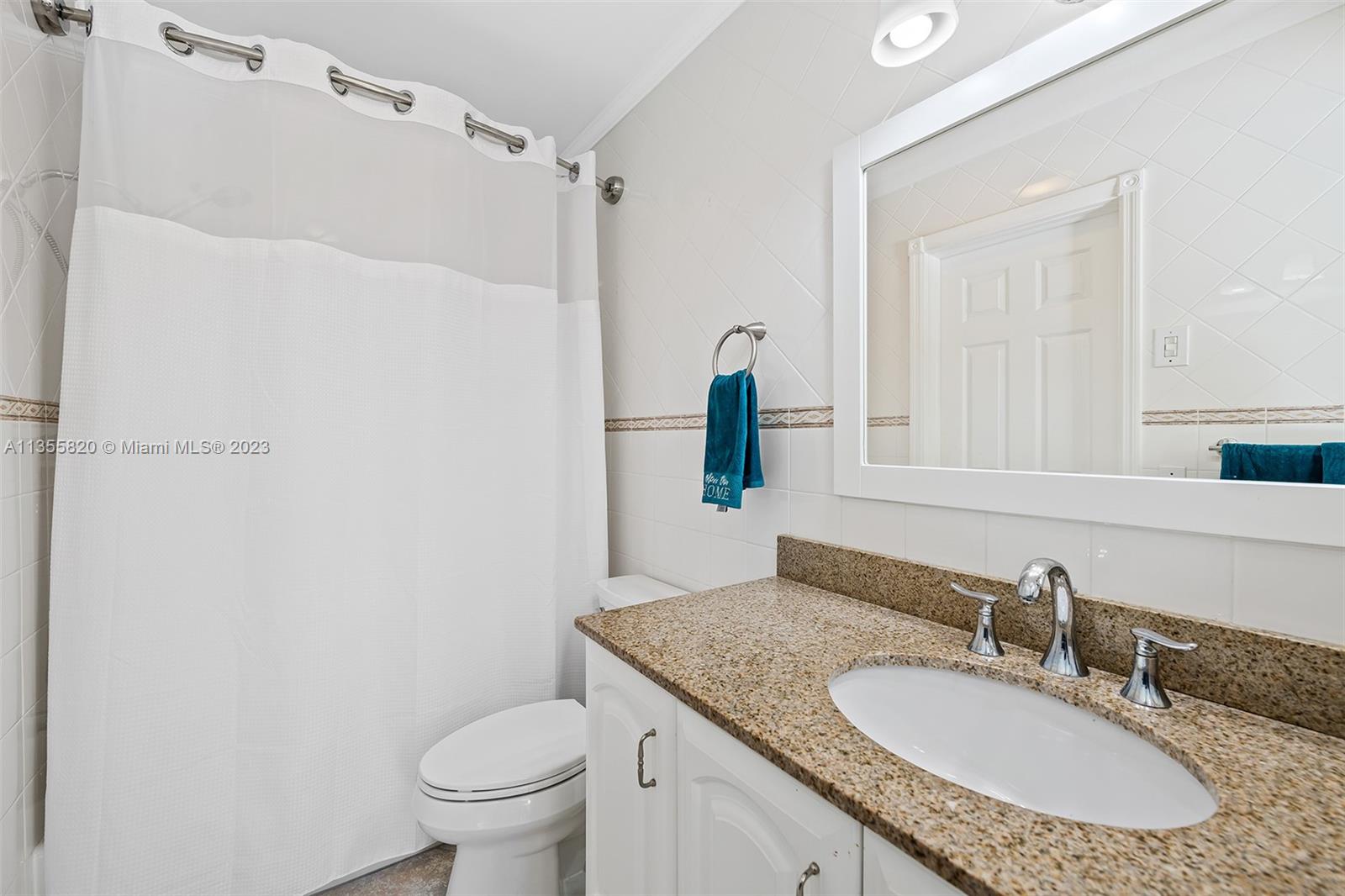 3731 Thomas Street Hollywood, FL 33021 - Photo 18 of 21 a bathroom with a granite countertop sink toilet and a mirror