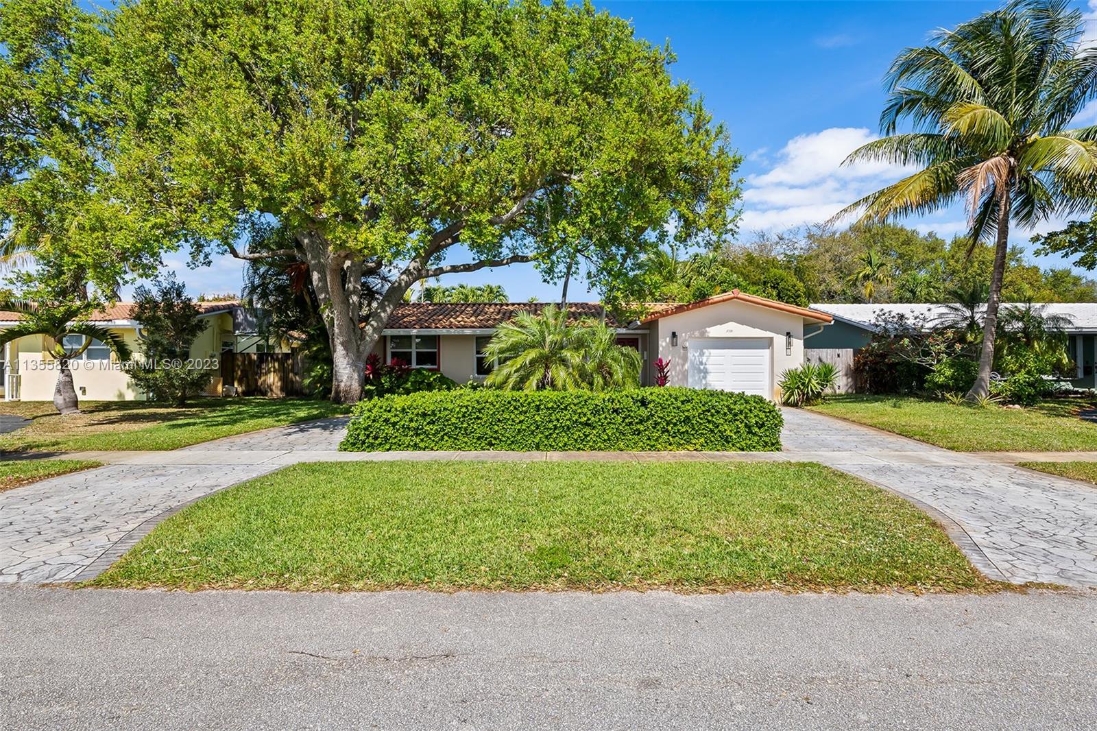 3731 Thomas Street Hollywood, FL 33021 - Photo 2 of 21 a front view of a house with a yard