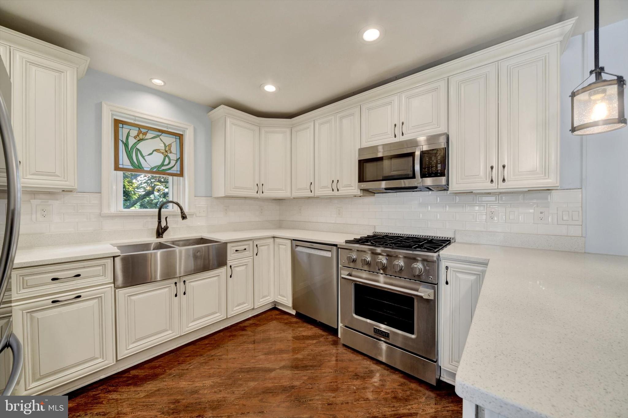 4220 East Joppa Road Nottingham, MD 21236 - Photo 14 of 35 a kitchen with white cabinets and white appliances