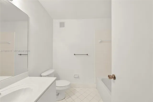 a bathroom with a toilet a sink and shower