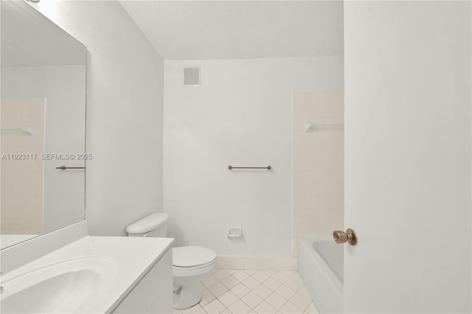 3385 Northeast 10th Street, Unit 201 Homestead, FL 33033 - Photo 11 of 15 a bathroom with a toilet a sink and shower