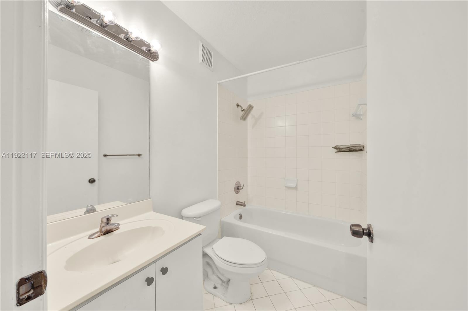 3385 Northeast 10th Street, Unit 201 Homestead, FL 33033 - Photo 14 of 15 a bathroom with a sink a toilet and shower