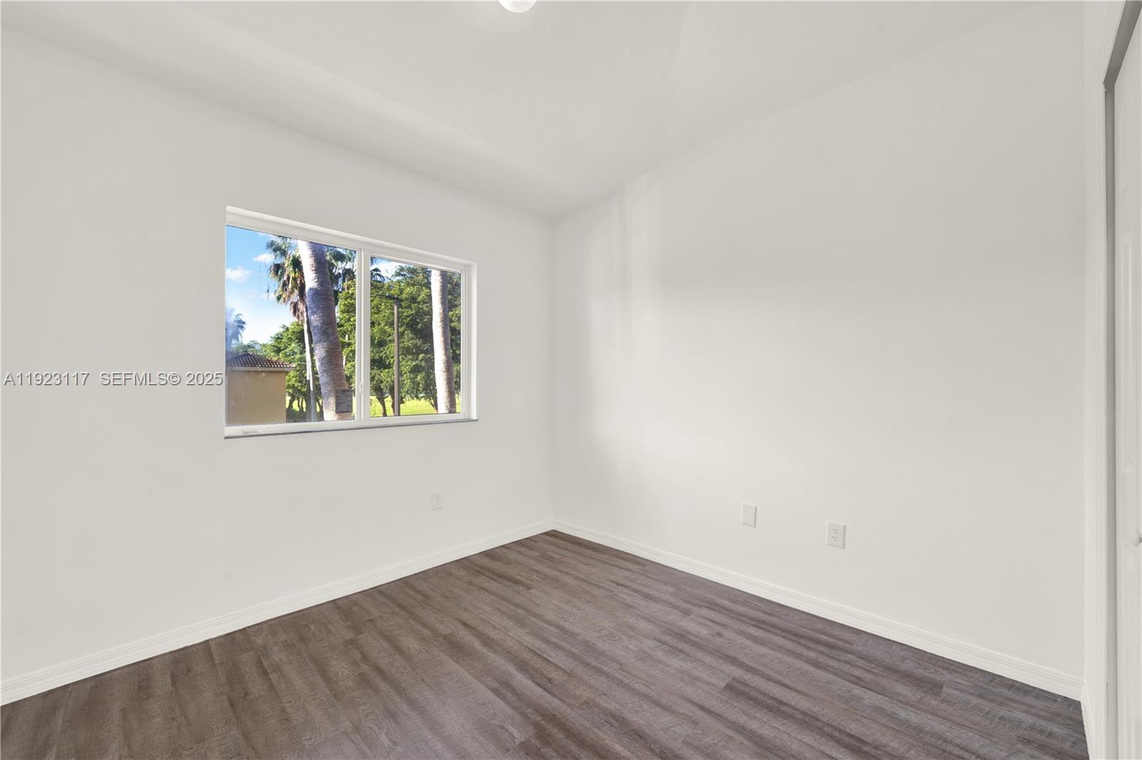 3385 Northeast 10th Street, Unit 201 Homestead, FL 33033 - Photo 15 of 15 an empty room with wooden floor and windows