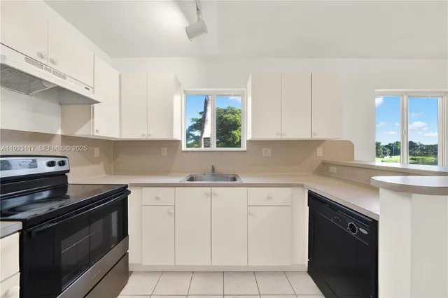 a kitchen with a sink stove and cabinets
