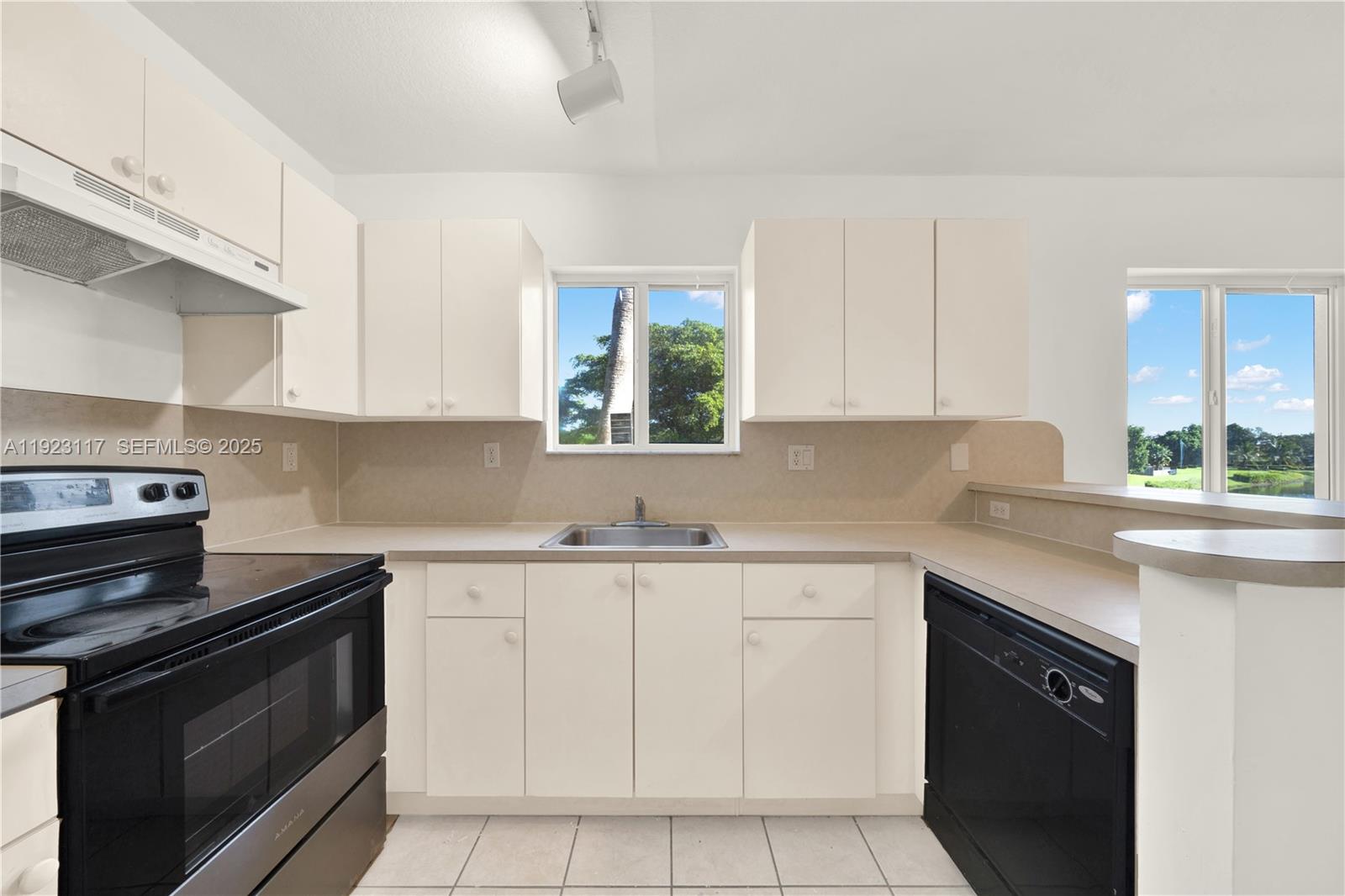3385 Northeast 10th Street, Unit 201 Homestead, FL 33033 - Photo 5 of 15 a kitchen with a sink stove and cabinets