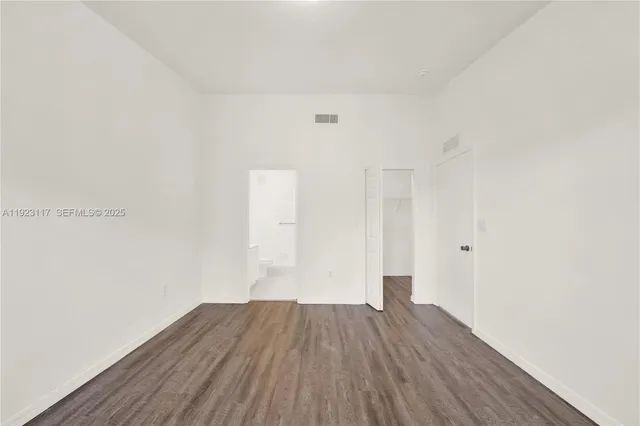 a view of a room with wooden floor and brick wall