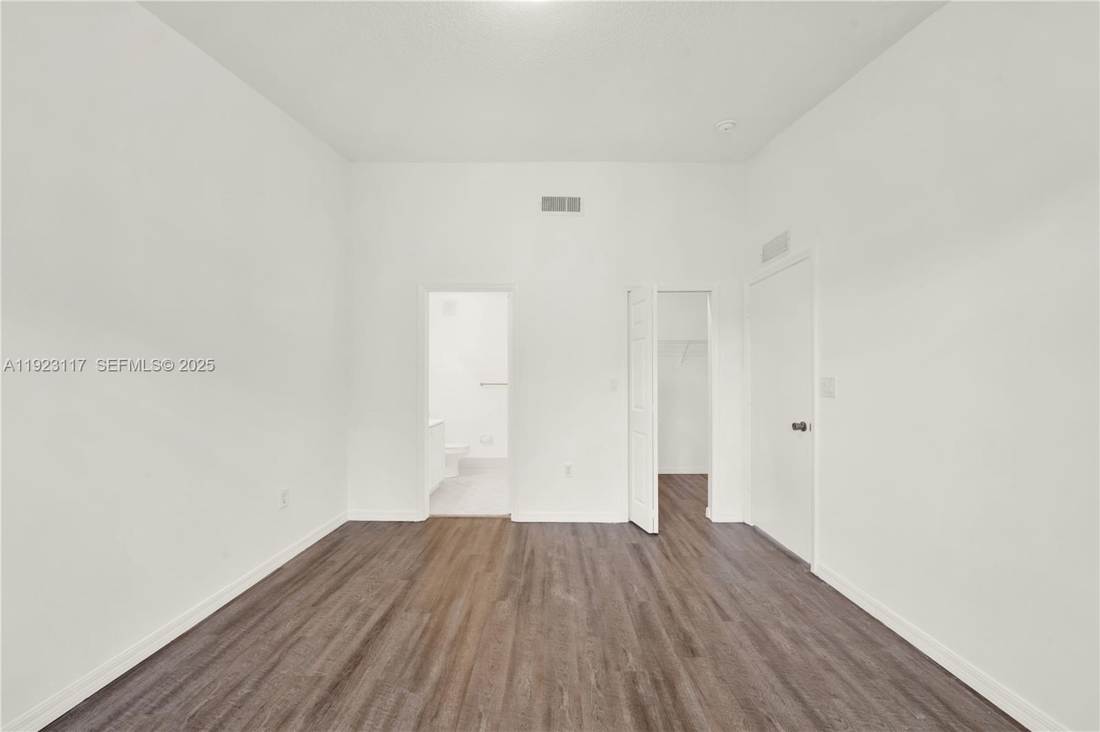 3385 Northeast 10th Street, Unit 201 Homestead, FL 33033 - Photo 9 of 15 a view of a room with wooden floor and brick wall
