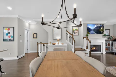 a dining room with furniture and wooden floor