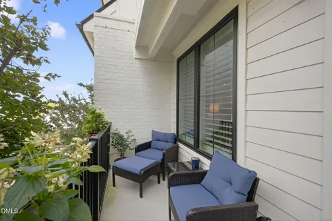 a view of a balcony with furniture