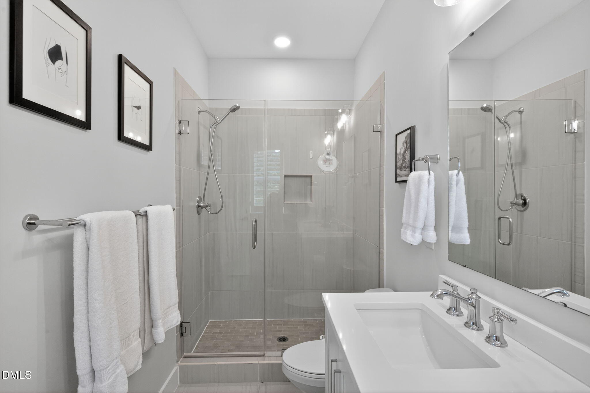 1610 Draper View Loop, Unit 102 Raleigh, NC 27608 - Photo 25 of 40 a bathroom with a sink toilet and shower