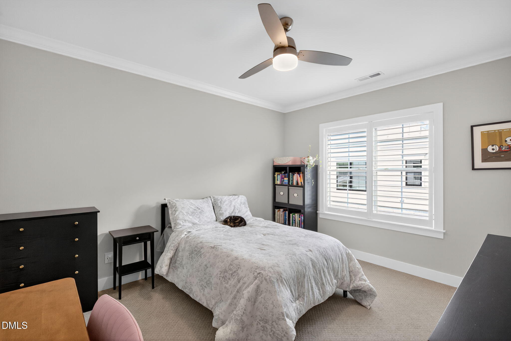 1610 Draper View Loop, Unit 102 Raleigh, NC 27608 - Photo 26 of 40 a bedroom with a bed and a chandelier