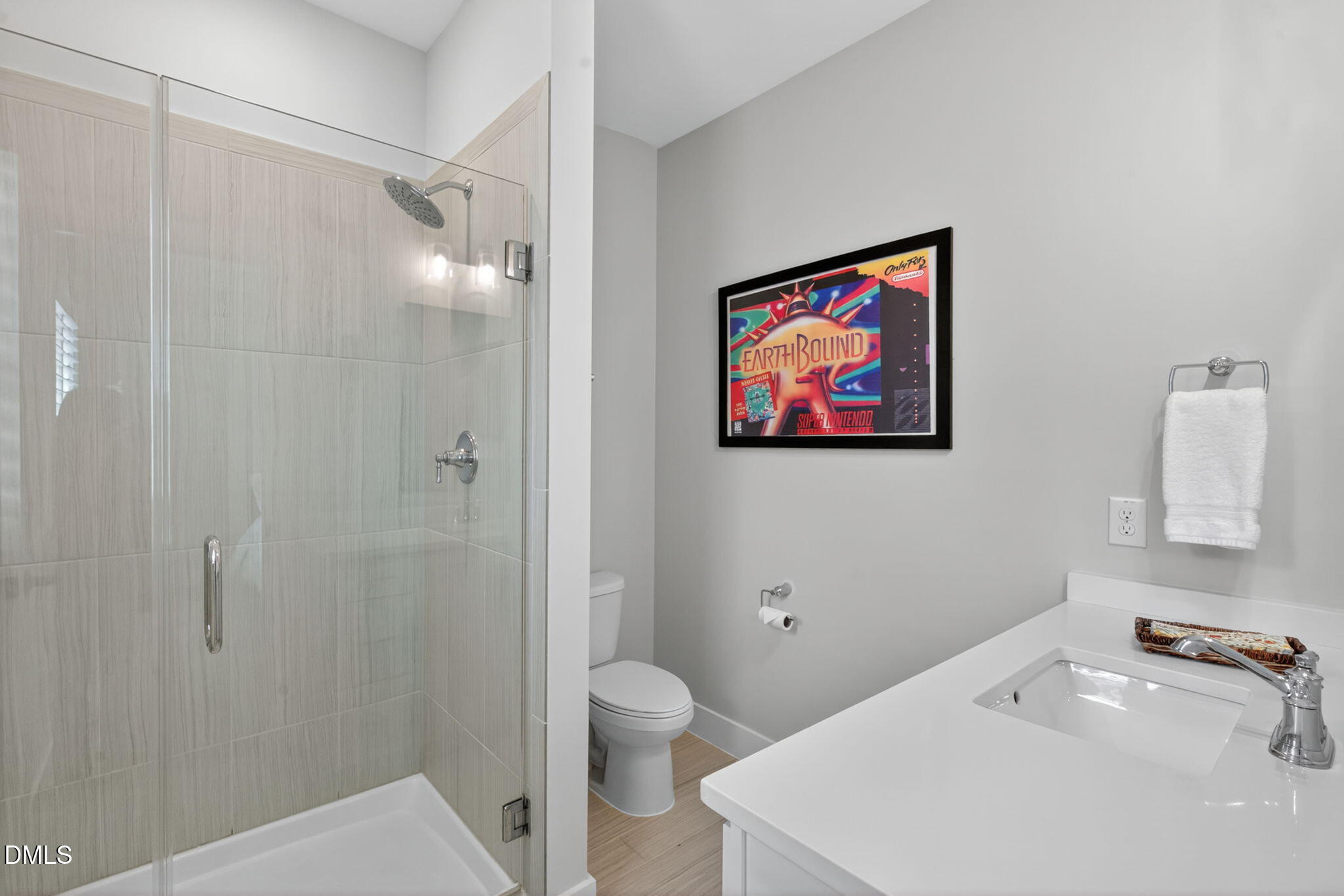 1610 Draper View Loop, Unit 102 Raleigh, NC 27608 - Photo 28 of 40 a bathroom with a sink a toilet and shower