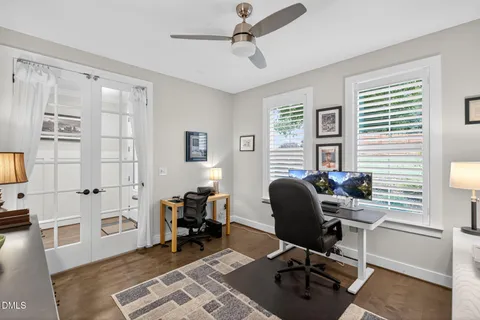 a view of a workspace with furniture and a window