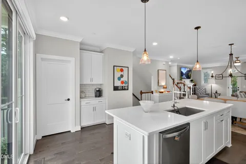 a kitchen with stainless steel appliances a microwave a stove and white cabinets