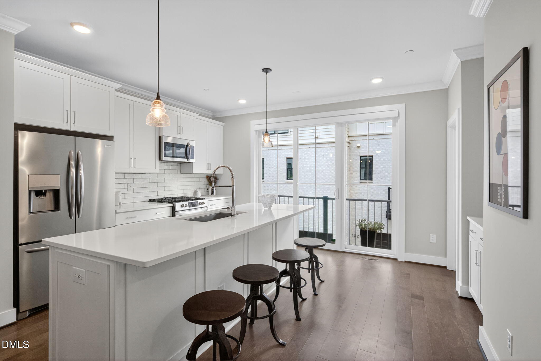 1610 Draper View Loop, Unit 102 Raleigh, NC 27608 - Photo 7 of 40 a kitchen with refrigerator and chairs