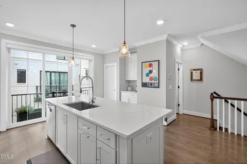 a kitchen with refrigerator and chairs