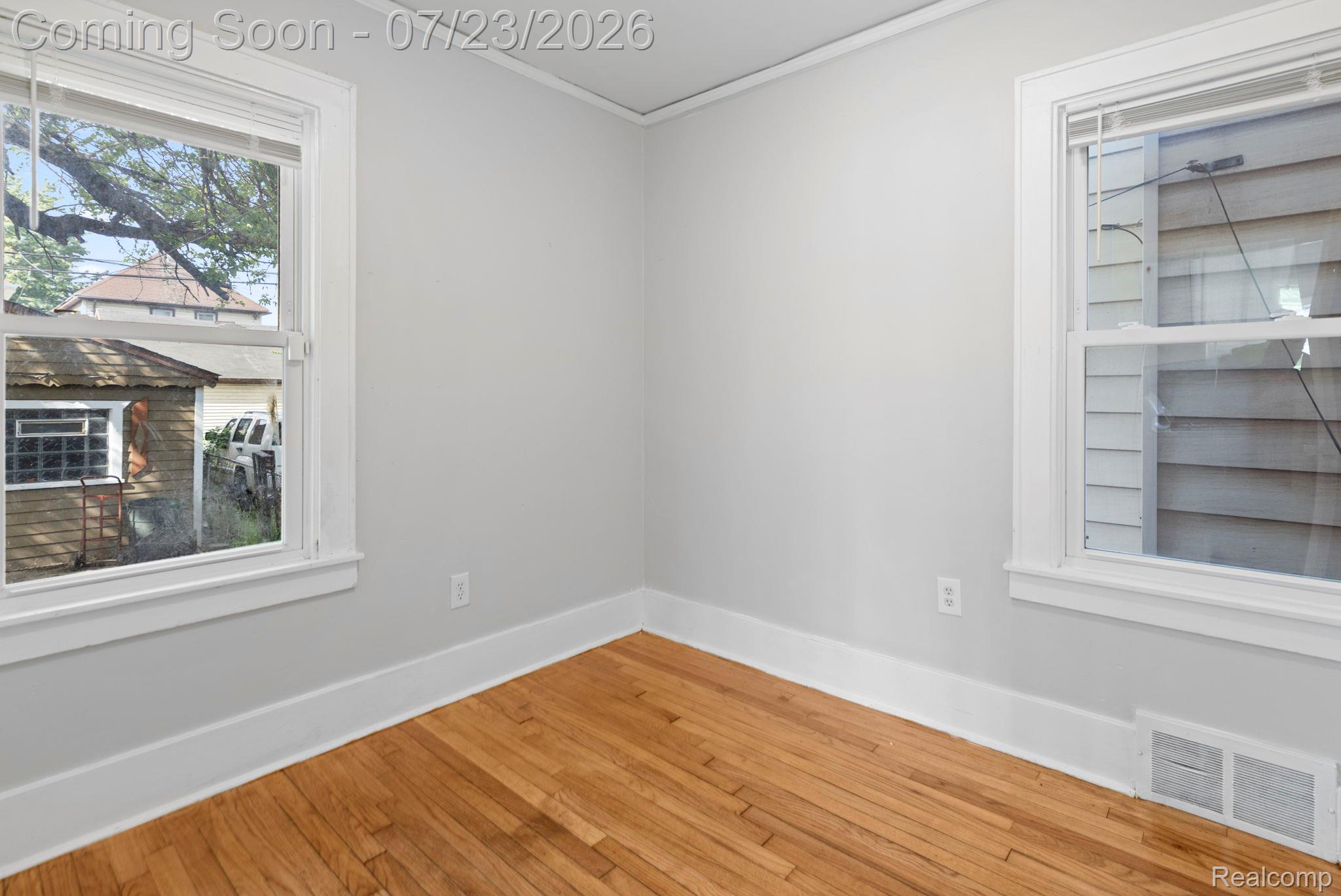 74 Pine Street River Rouge, MI 48218 - Photo 16 of 29 Empty room featuring crown molding and light wood-style flooring