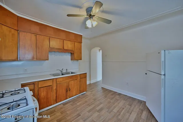 a kitchen with stainless steel appliances a stove a refrigerator and cabinets