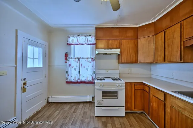a view of kitchen with cabinets and wooden floor