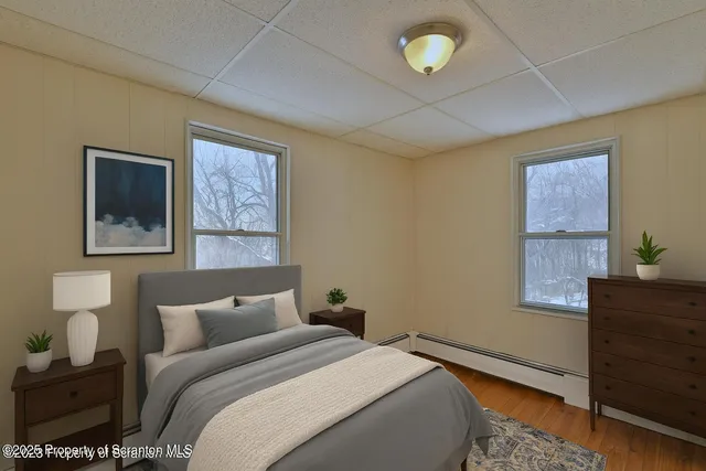 a bedroom with a bed and a lamp on dresser