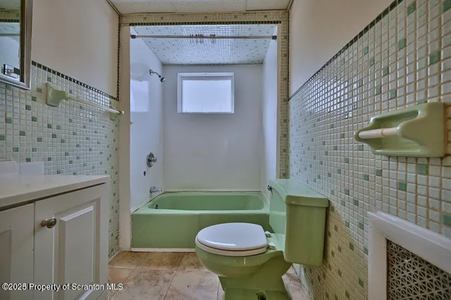 a bathroom with a toilet a sink and bathtub