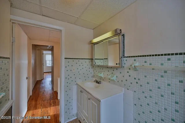 a bathroom with a sink a mirror and shower