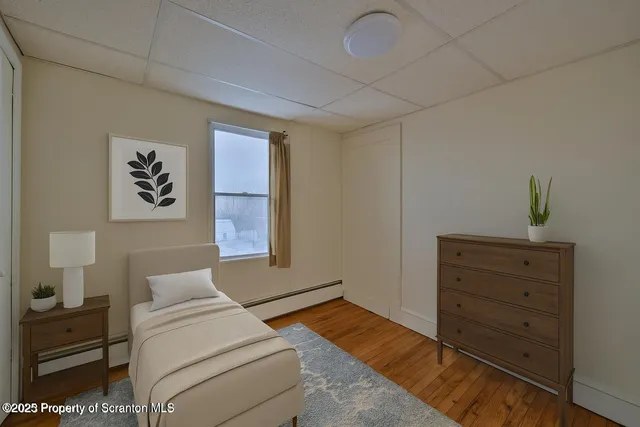 a bedroom with a bed and a dresser