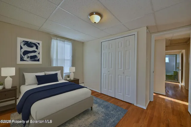 a bedroom with a large bed and a window