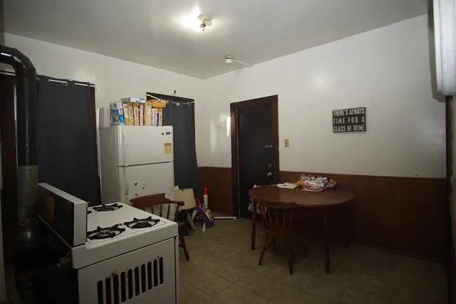 a room with furniture and a refrigerator