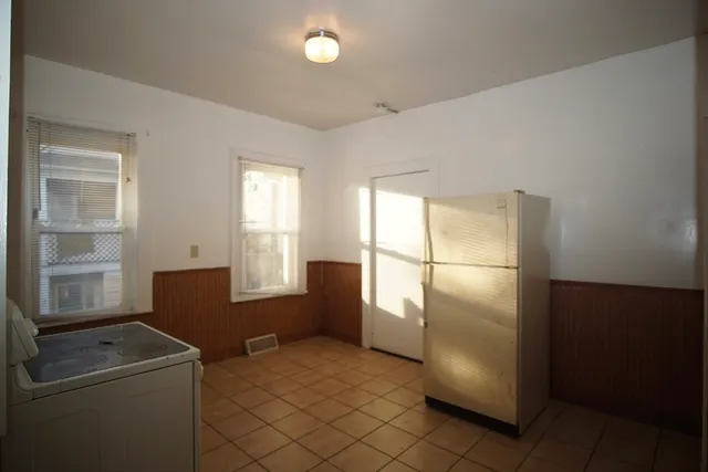 a kitchen with refrigerator and window