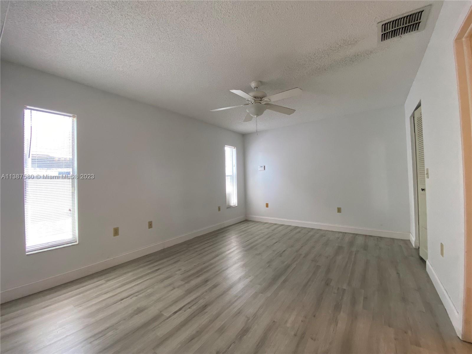 11652 Sunshine Pond Road Tampa, FL 33635 - Photo 20 of 39 wooden floor in an empty room with a window
