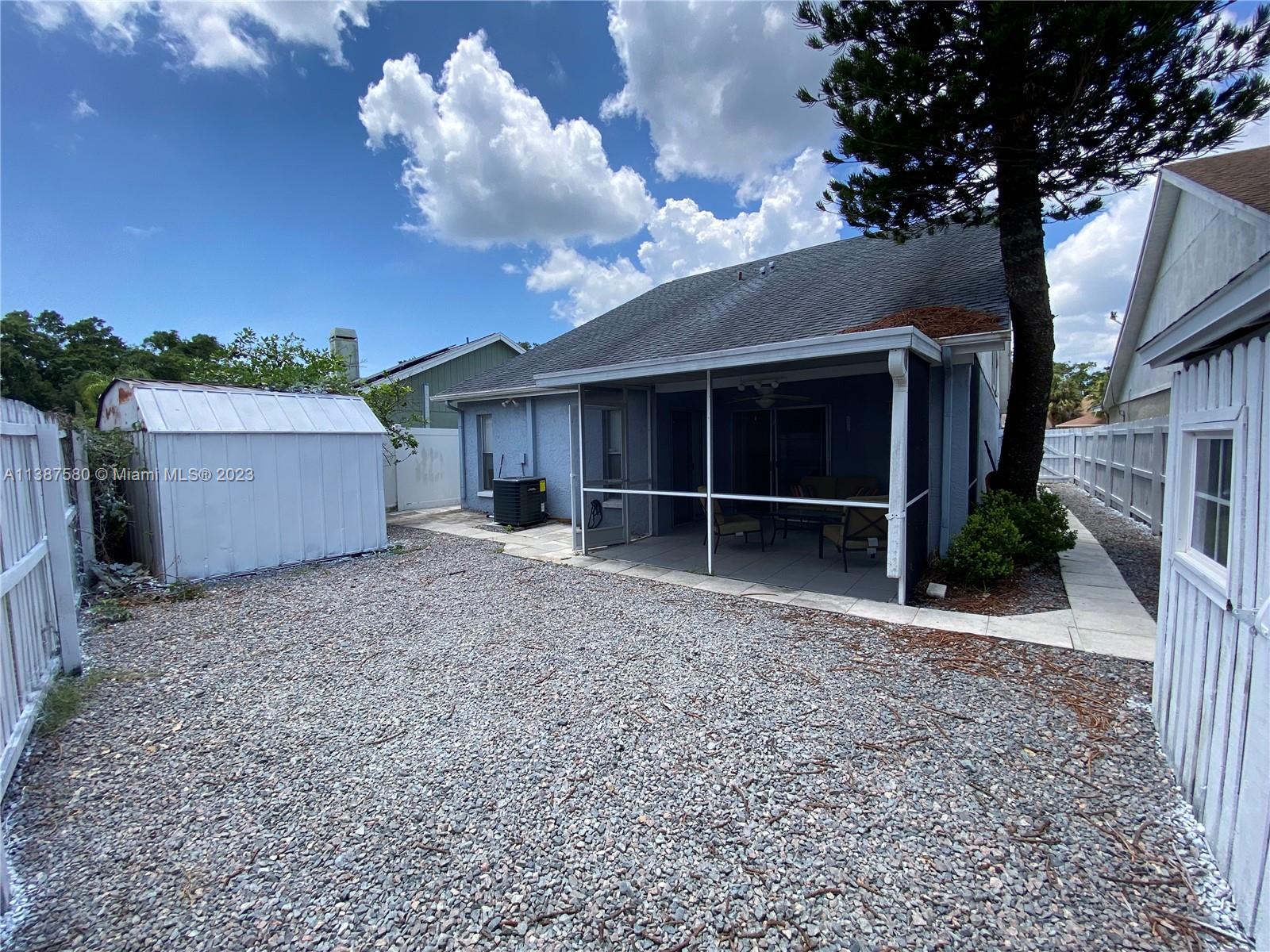 11652 Sunshine Pond Road Tampa, FL 33635 - Photo 28 of 39 a view of a house with a yard and a large tree