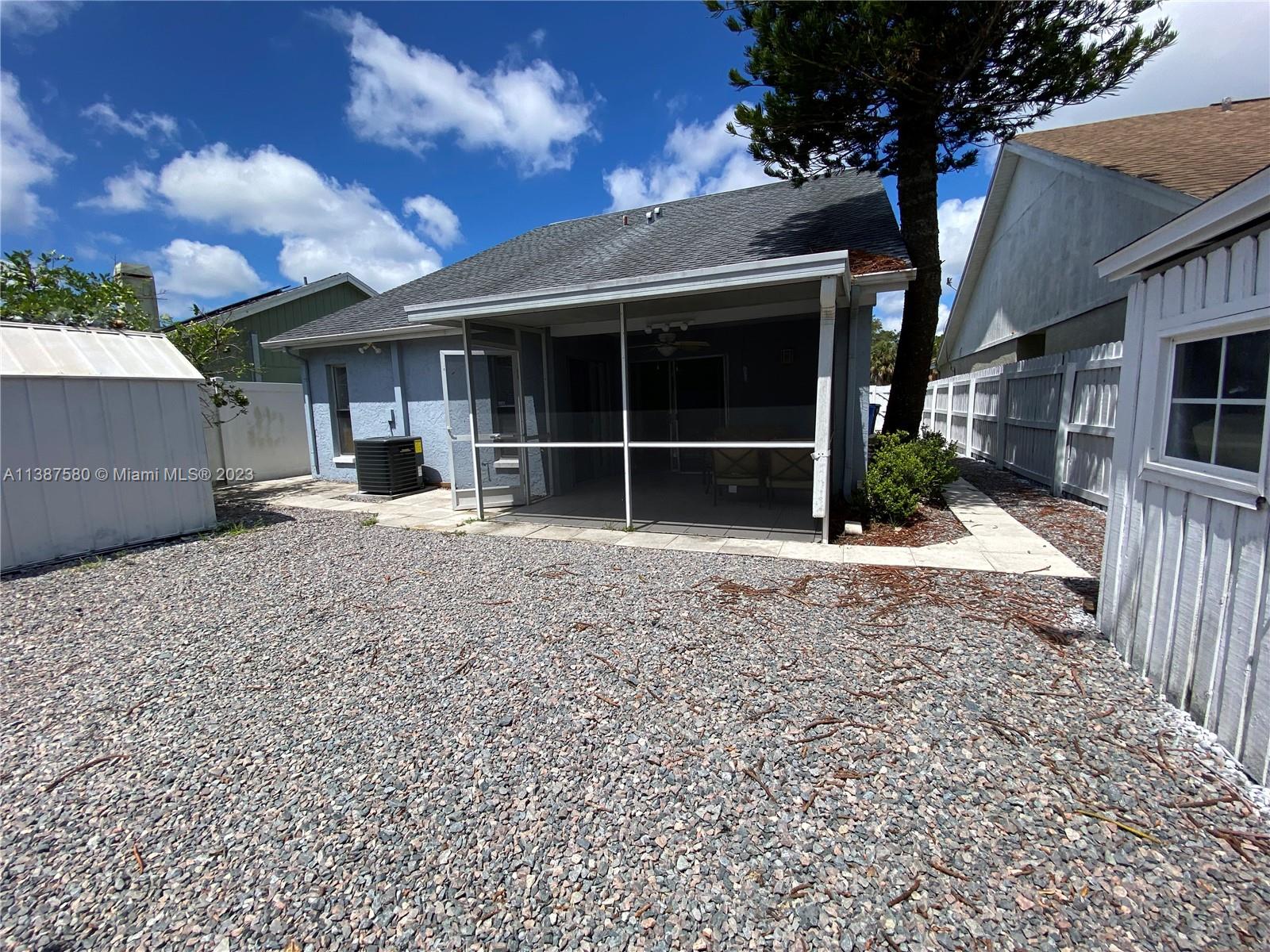 11652 Sunshine Pond Road Tampa, FL 33635 - Photo 35 of 39 a view of a house with a yard and garage