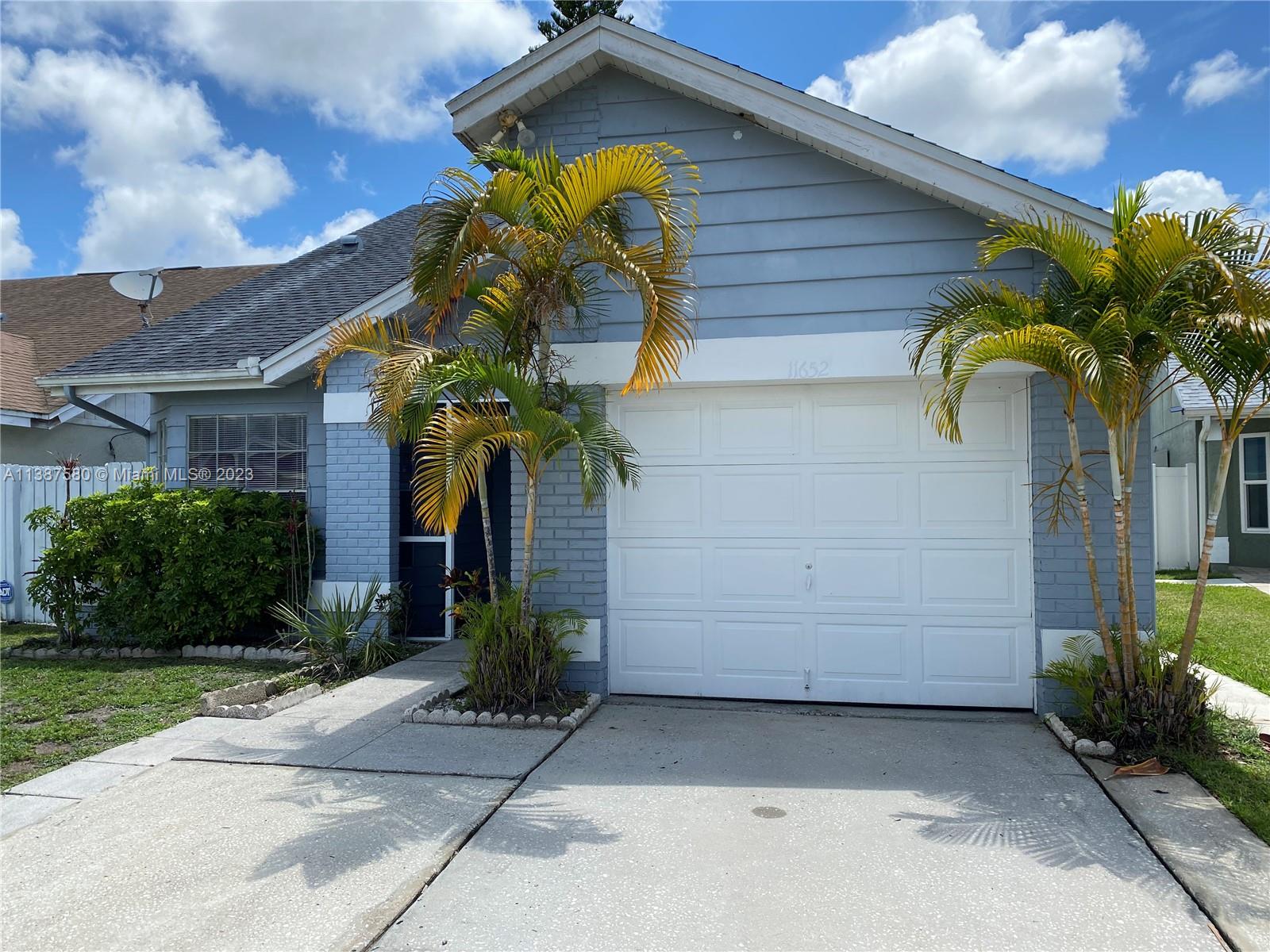11652 Sunshine Pond Road Tampa, FL 33635 - Photo 39 of 39 a view of a house with a small yard and plants