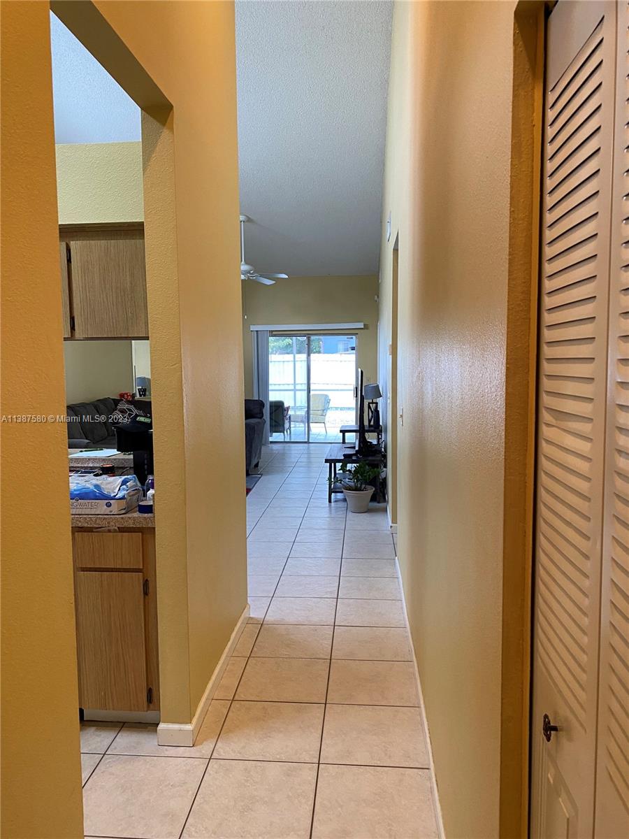 11652 Sunshine Pond Road Tampa, FL 33635 - Photo 6 of 39 a hallway with a washer and dryer