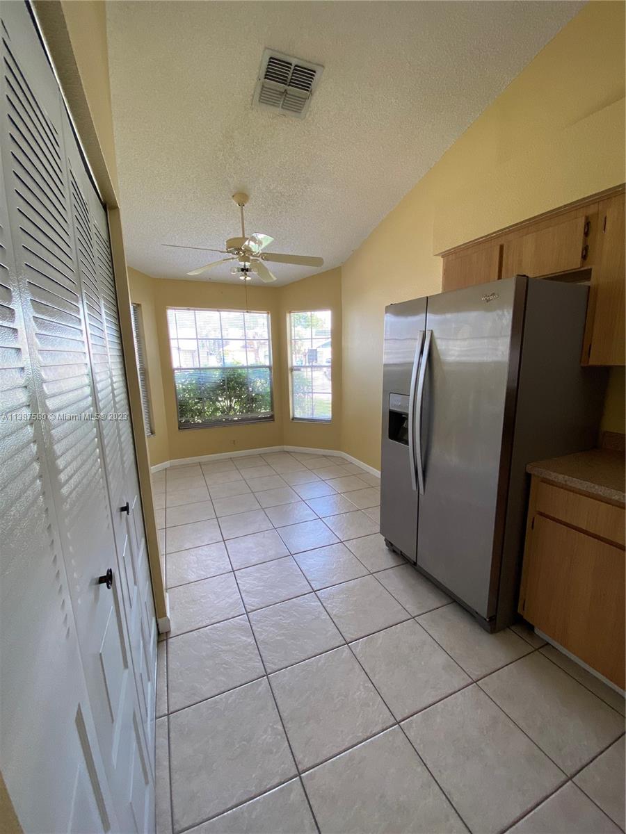 11652 Sunshine Pond Road Tampa, FL 33635 - Photo 7 of 39 a view of a refrigerator in kitchen and an empty room