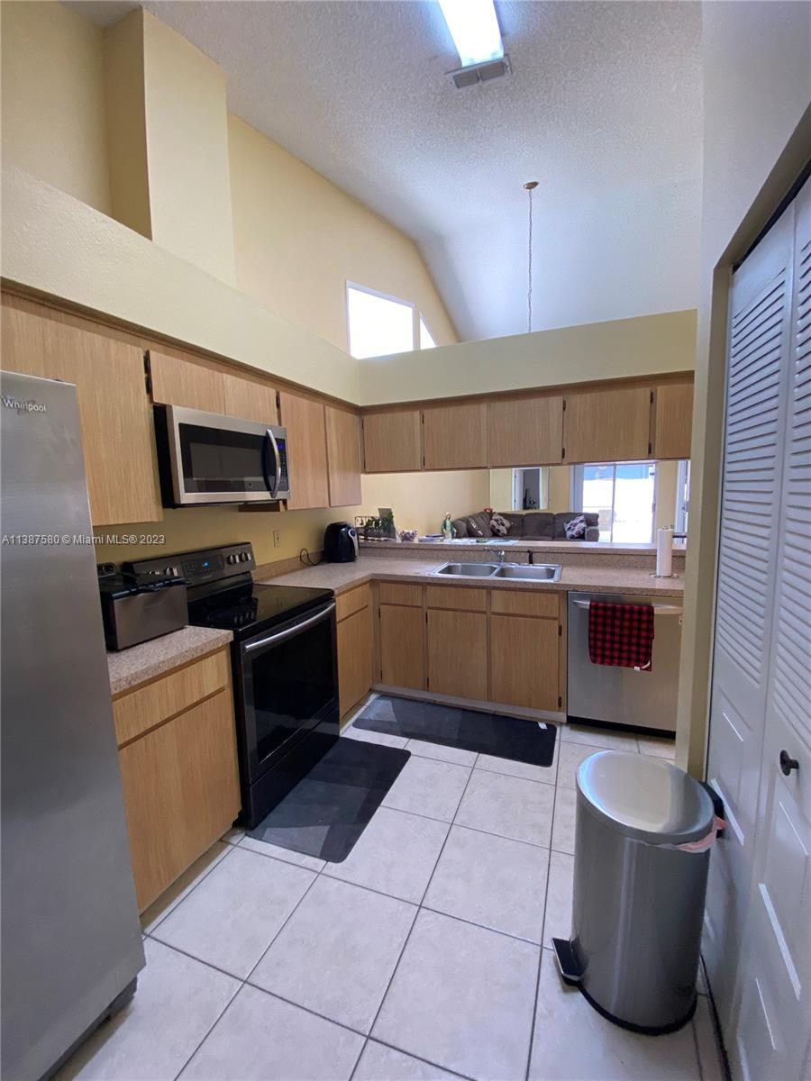 11652 Sunshine Pond Road Tampa, FL 33635 - Photo 10 of 39 a kitchen with a sink a stove and cabinets