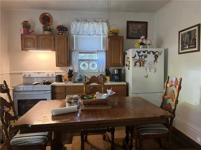 a view of a dining room with furniture and a chandelier