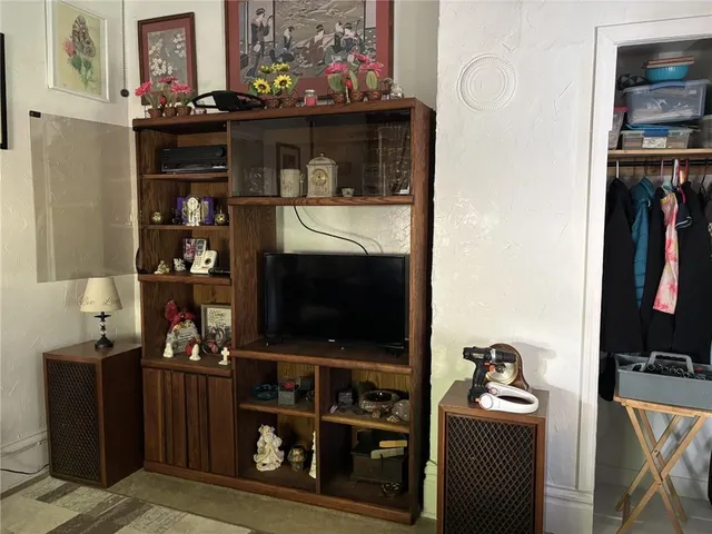 a room with wine cabinets and a flat screen tv