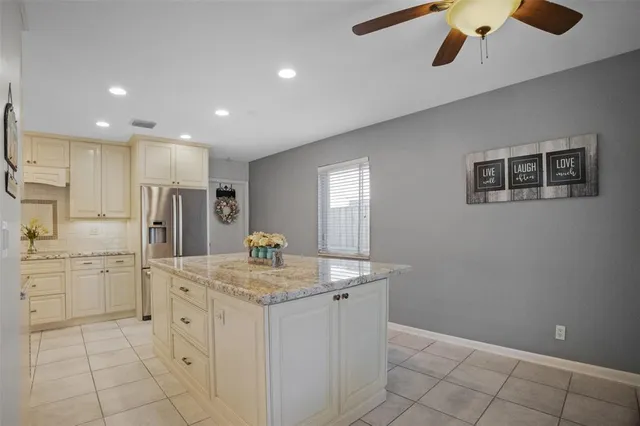 a bedroom with a bed and a ceiling fan