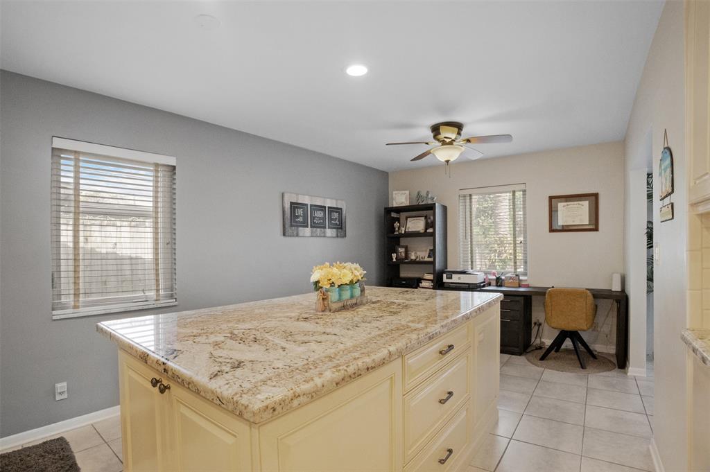 223 Southeast 7th Street Dania Beach, FL 33004 - Photo 17 of 50 a hall with kitchen countertops a stove and a dining table