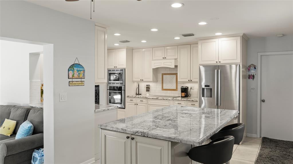 223 Southeast 7th Street Dania Beach, FL 33004 - Photo 18 of 50 a kitchen with stainless steel appliances granite countertop a refrigerator and a sink