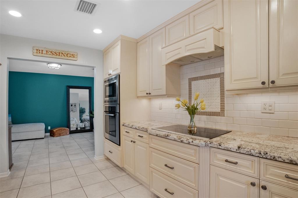 223 Southeast 7th Street Dania Beach, FL 33004 - Photo 19 of 50 a kitchen with granite countertop a sink and white cabinets