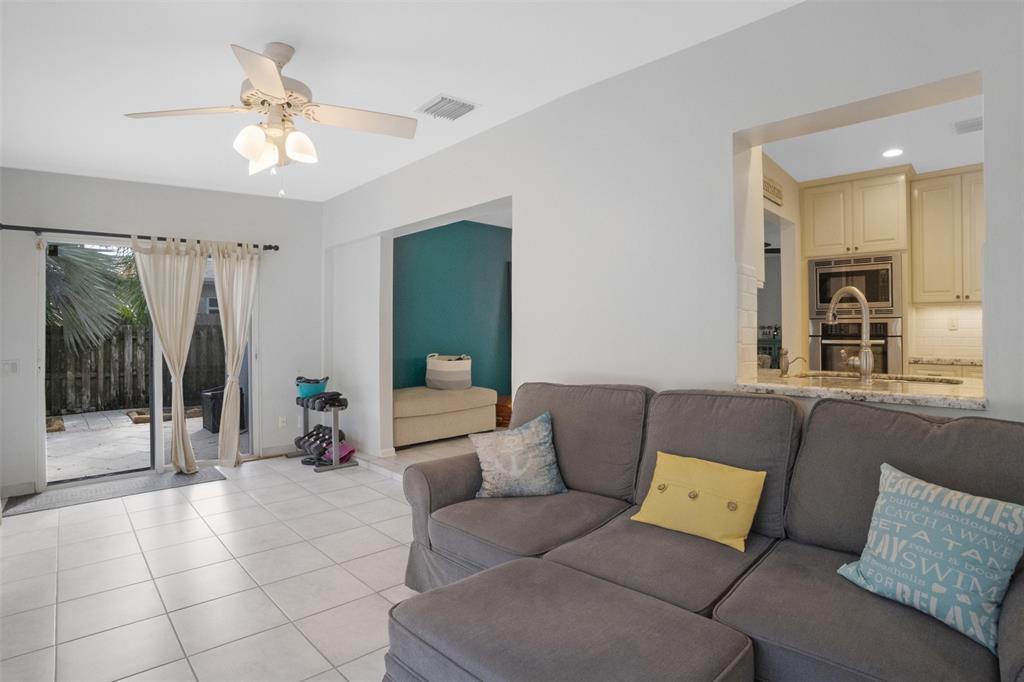 223 Southeast 7th Street Dania Beach, FL 33004 - Photo 22 of 50 a living room with furniture and a glass door shower