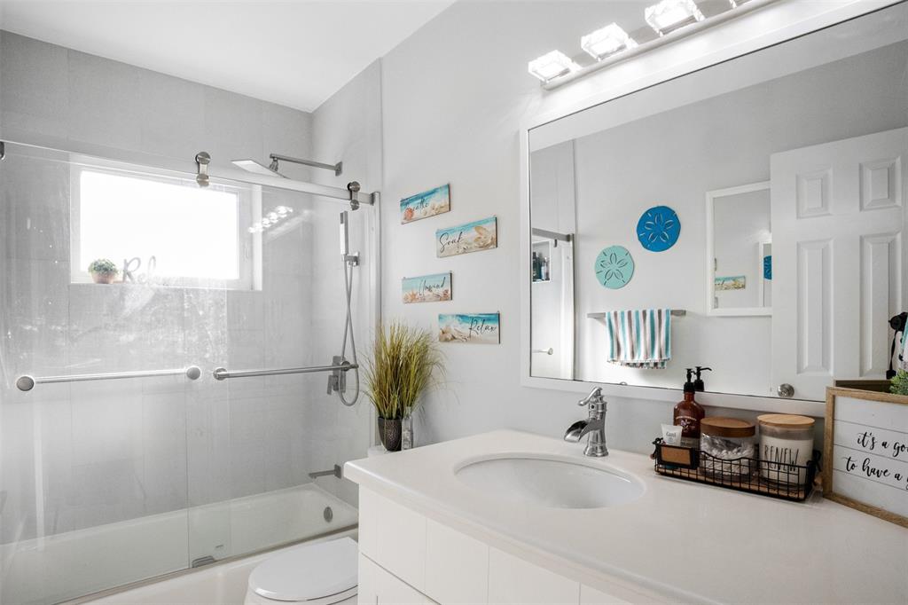 223 Southeast 7th Street Dania Beach, FL 33004 - Photo 29 of 50 a bathroom with a sink and a mirror a bathtub